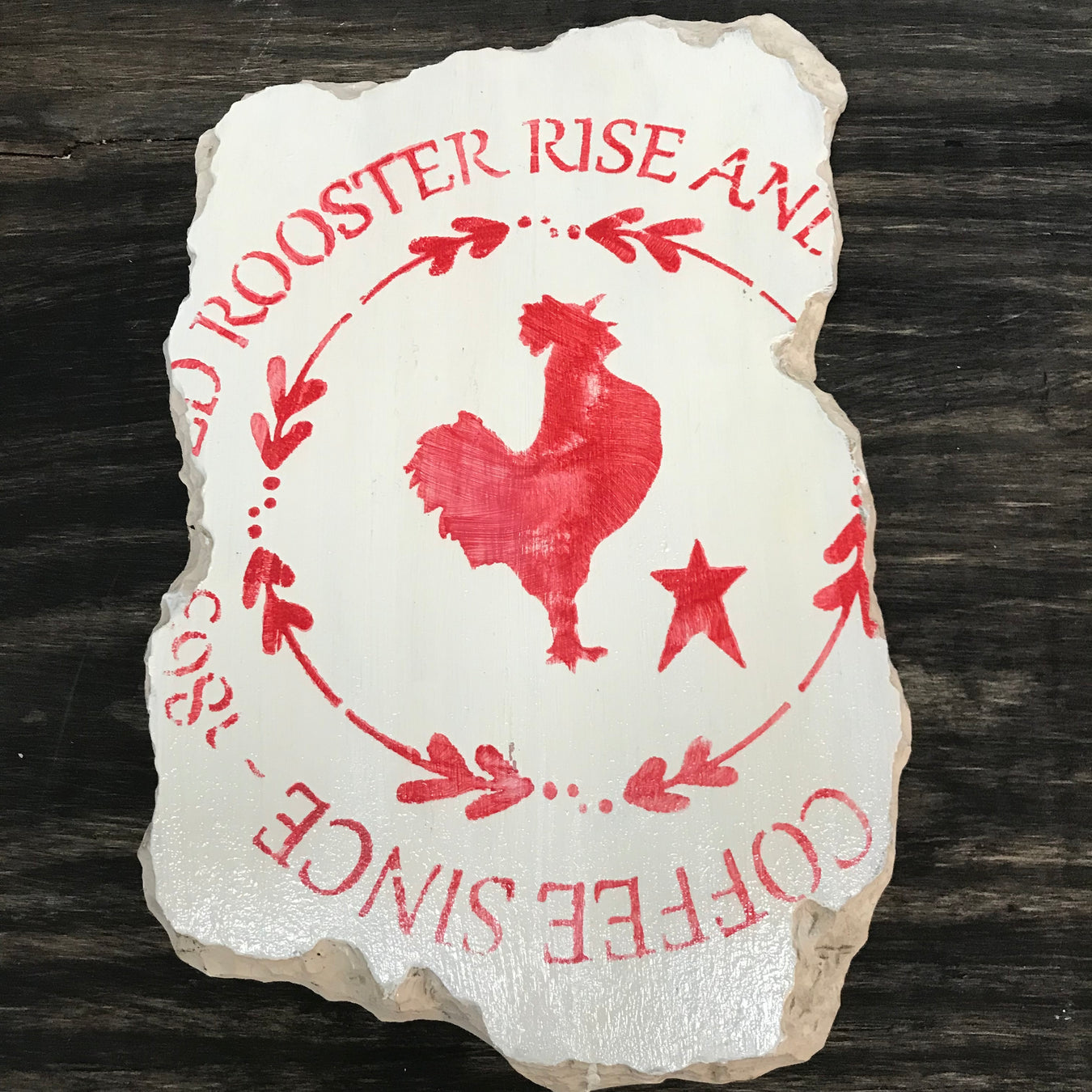 red rooster rise and shine coffee advertising sign painted on concrete using paint stencil
