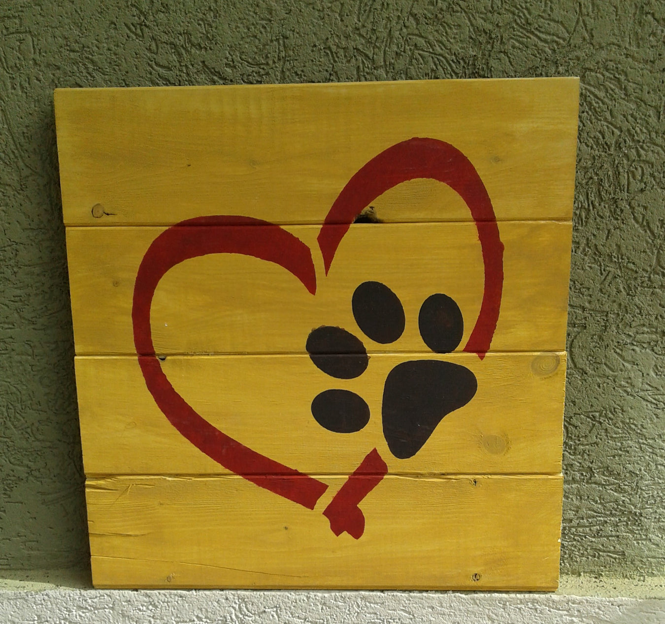 dog paw and heart painted on wood using paint stencil