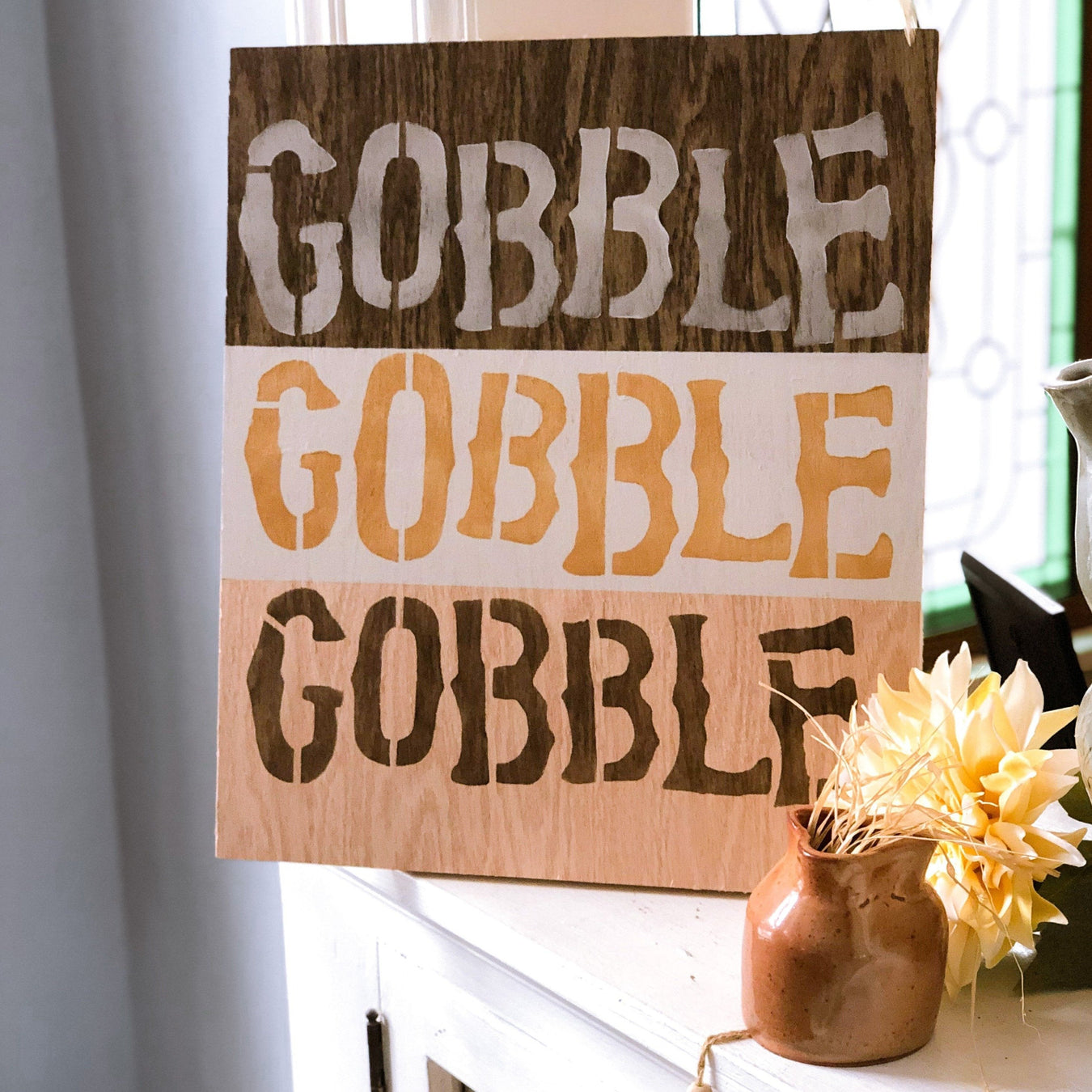 stenciled gobble gobble gobble words painted on wood as thanksgiving decor