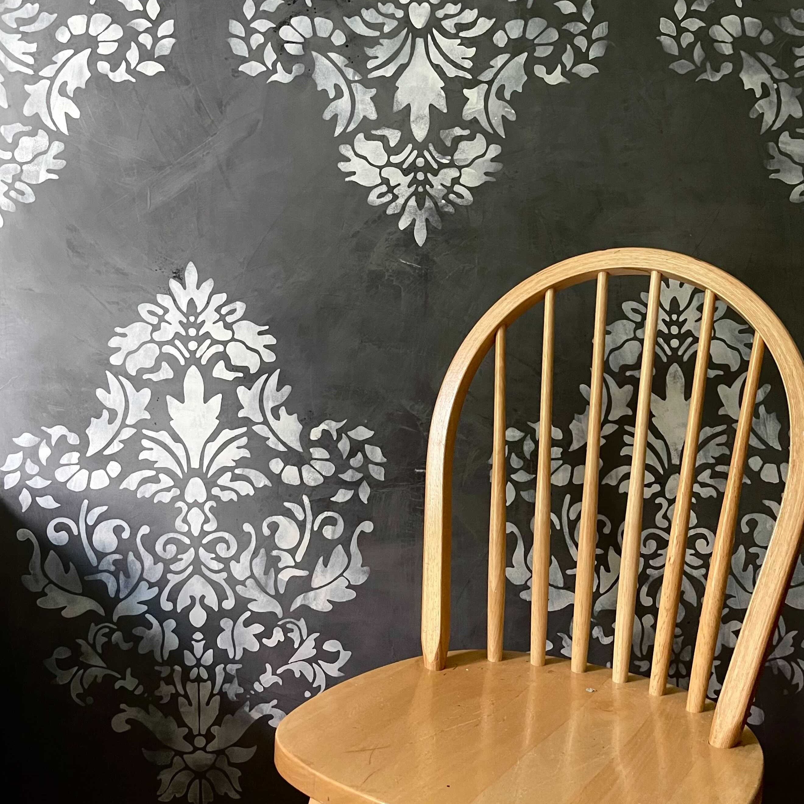 stenciled damask design painted on wall