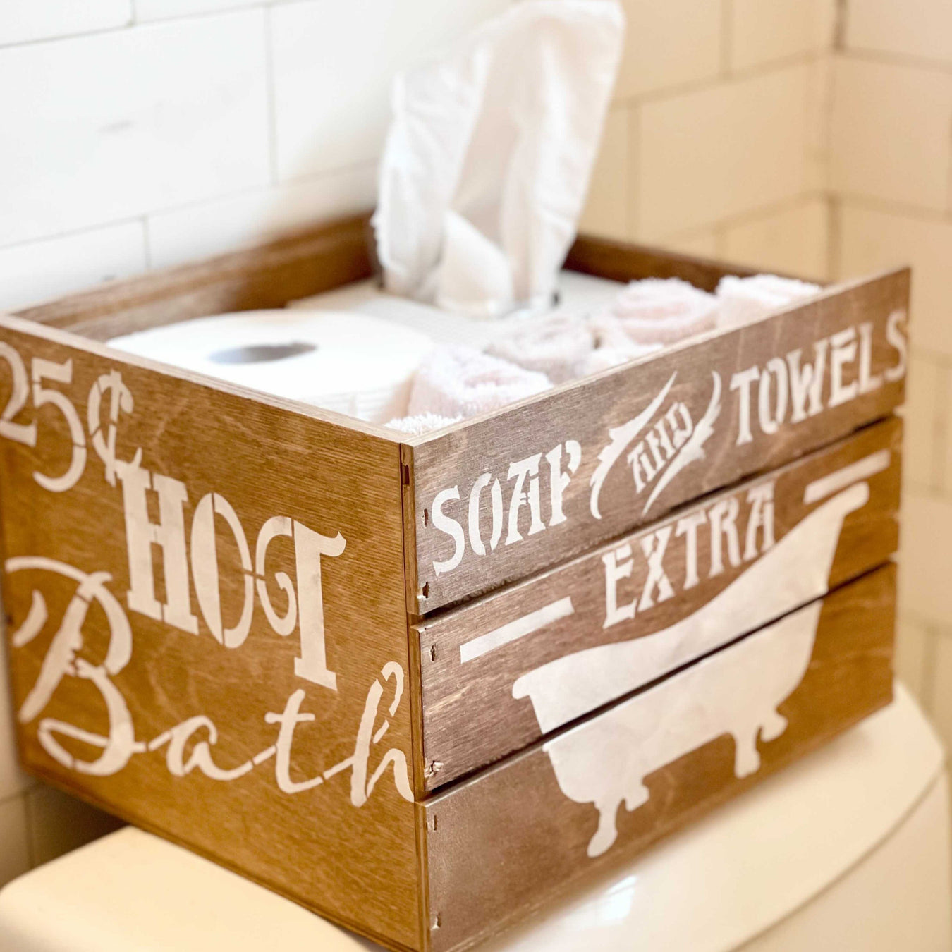 a wooden crate decorted with hot bath, soap and towels using paint stencil