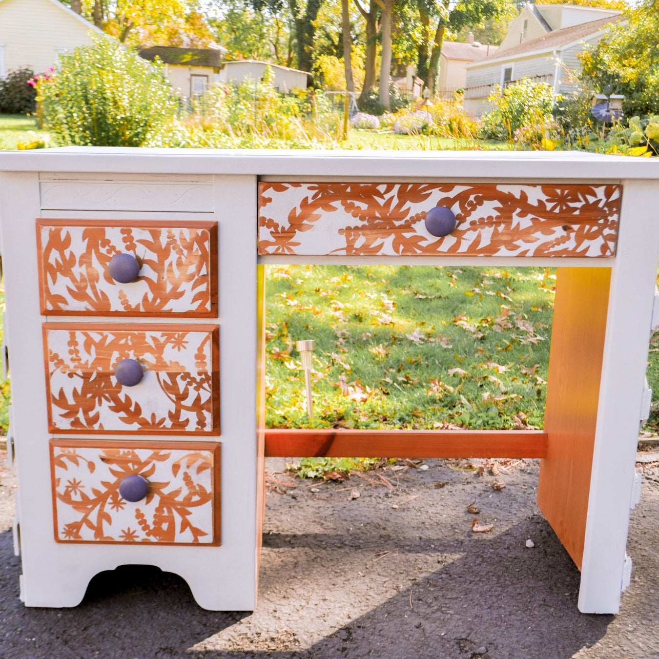 wooden desk painted with japanese ornate pattern painted on its drawers using japanese stencil