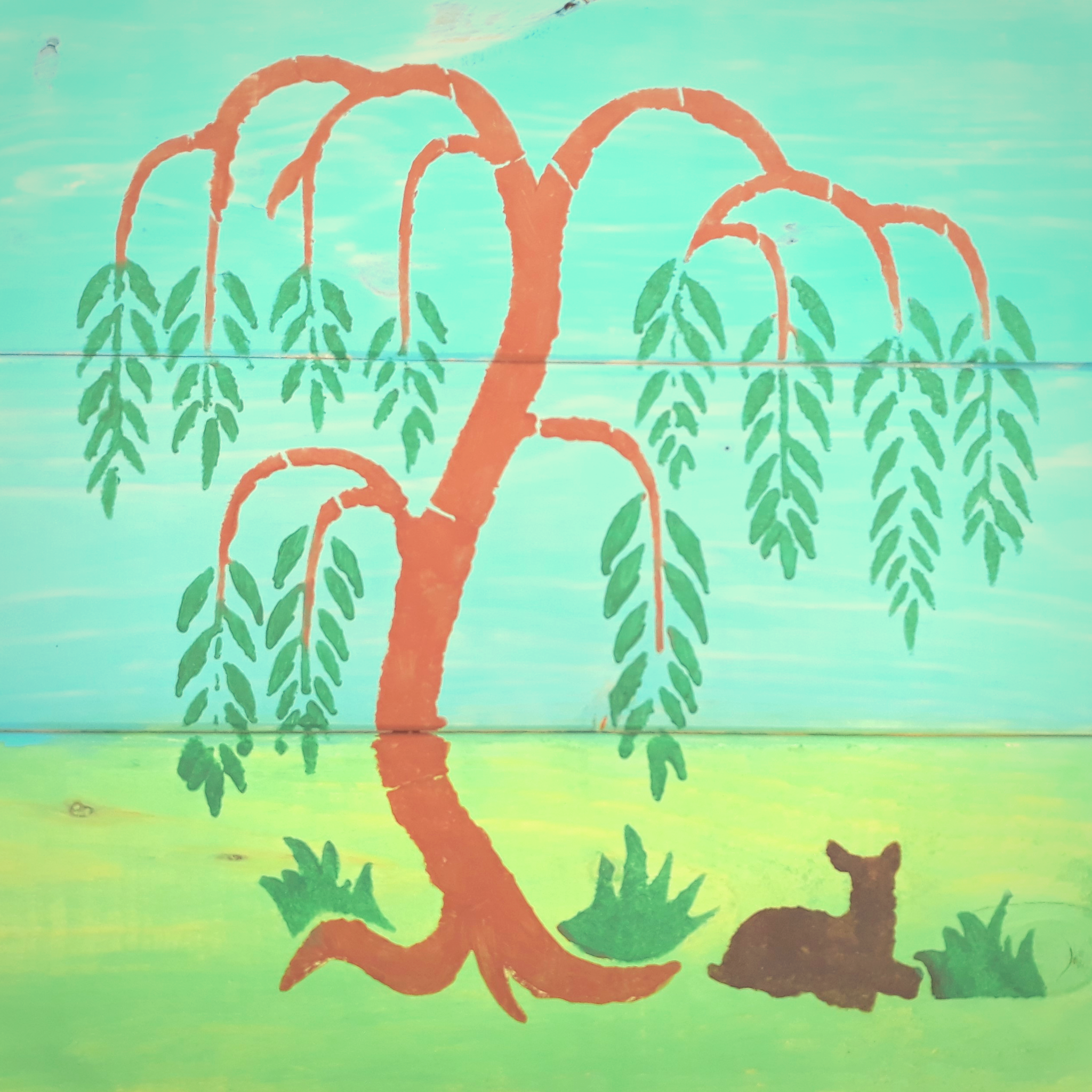 stenciled willow tree and a deer painted on wood